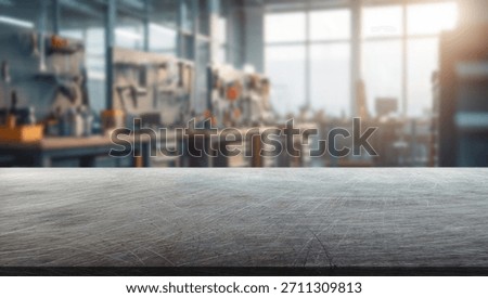 Interior of a modern workshop with many tools and a steel tabletop in the foreground