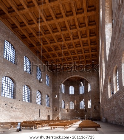 Interior nave with coffered wood ceiling and tall windows inside the Konstantin Basilika in Trier, Germany.