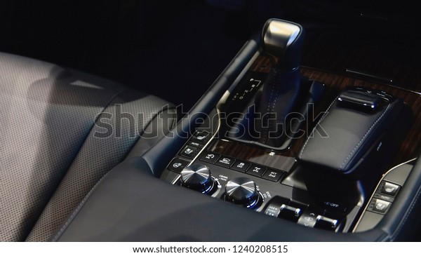 interior of a new\
car, view of the central panel with a gear selector, leather seats\
with black upholstery