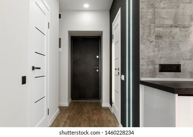 Interior Of New Empty Apartment, Long Home Corridor With Parquet Floor, White Wall And Doors, Copy Space. Entrance Corridor