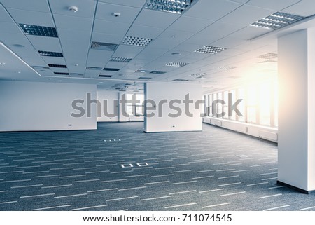 Interior of the new empty office building at sunset time.