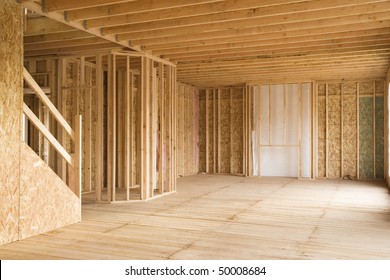 Interior Of A New Home Under Construction, With Stairs To The Left And An Opening For A Fireplace In The Background. Horizontal Shot.