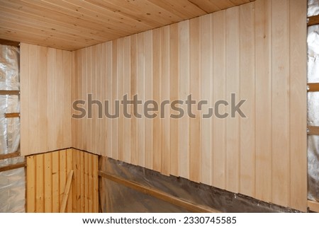 Interior of a new sauna under construction. Wooden walls and ceiling