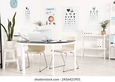 Interior of oculist's office with workplace and eye test charts - Powered by Shutterstock