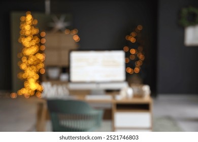 Interior of office with programmer's workplace decorated for Christmas, blurred view