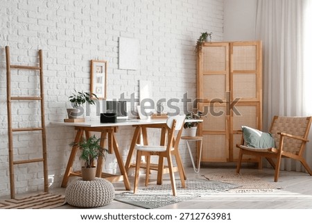 Interior of office with workplace and aroma diffuser