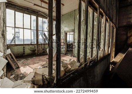 Interior of a old and abandoned coal mine factory, with lots of rusty metal and iron.