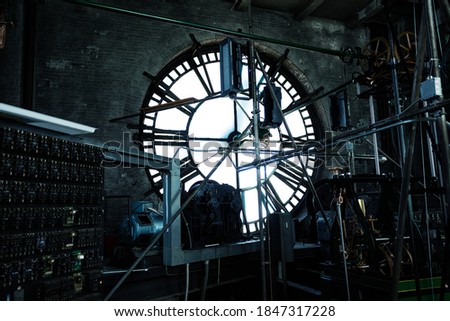 Interior of old big tower clock face mechanism inside brick space