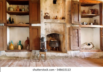Interior of old house in Georgia country, with kitchen utensils, kettle, primus, fireplace and the wooden floor