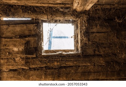 Interior of old wooden barn. Inside the rural barn. Wooden beam wall of the stable with a small window