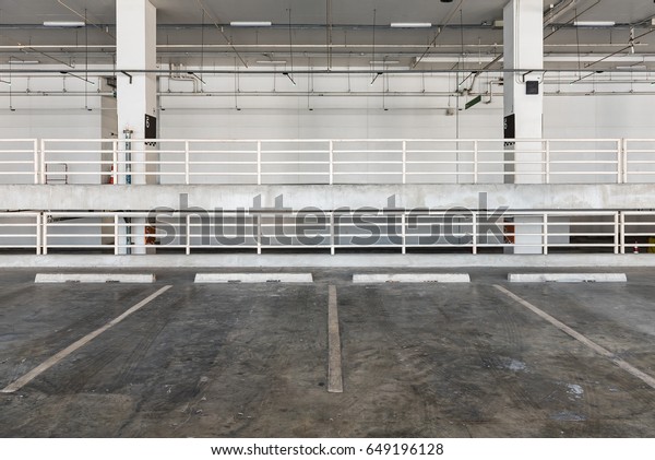 interior of parking garage with car and vacant\
parking lot in parking\
building