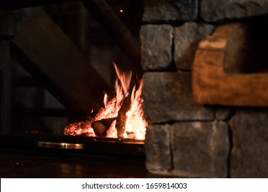 Interior photo of a mountain chalet on the Volcano Etna, volcanic stone fireplace