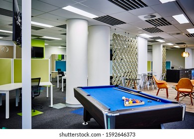 Interior Photography Of Commercial Fit Out Of Modern Office Break Out Area With Orange Chairs, Decorative Room Divider And Pool Table And Tables And Chairs With Office And Kitchen In Background