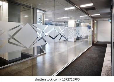 Interior photography of commercial fit out of corporate office, glass with decal on outside of reception area looking in