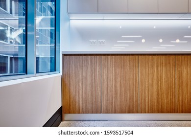 Interior Photography Of Commercial Fit Out Of Modern Office Break Out Area Detail Of Kitchen Cupboards With Glass Splash Back And Windows With City Background