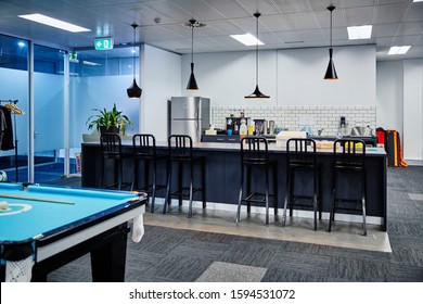 Interior Photography Of Commercial Fit Out Of Modern Office Break Out Area In Open Plan Office, Pendant Lighting, Kitchen With Breakfast Bar Meals Area And A Pool Table Off To The Side