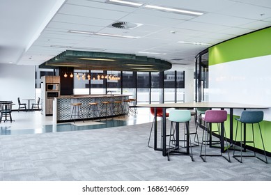 Interior Photography Of A Contemporary Design Corporate Office Break Out Area, A Kitchen With Pendant Lighting, Breakfast Bar & Stools And Lunch Tables