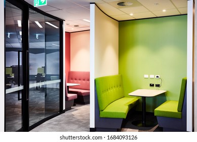 Interior Photography Of A Contemporary Design Divided Booth Work Spaces In Lime Green And Pink With Grey Carpet