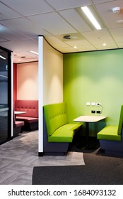 Interior Photography Of A Contemporary Design Divided Booth Work Spaces In Lime Green And Pink With Grey Carpet