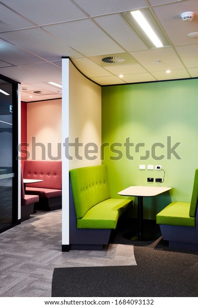 Interior photography
of a contemporary design divided booth work spaces in lime green
and pink with grey
carpet