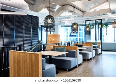 Interior Photography Of A Contemporary Designer Corporate Office Breakout Area With Booths, Pendant Lighting And Polished Concrete Floors