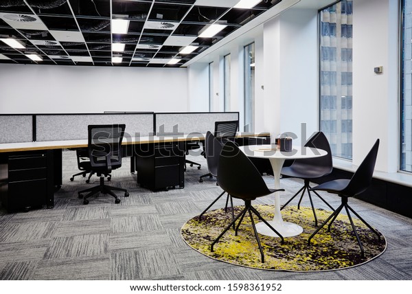 Interior photography of\
a corporate fit out open plan office with meeting area and city\
view in background