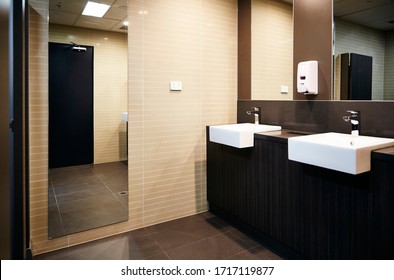 Interior Photography Of A Corporate Office Bathroom With Hand Basins And A Full Length Mirror