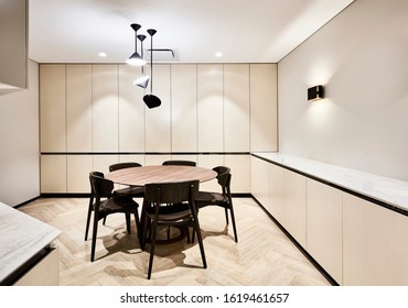 Interior Photography Of Corporate Office Breakout Area In Neutral Beige Tones With Kitchen Area And Pendant Lighting