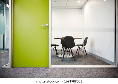 Interior Photography Of A Corporate Office Meeting Room Shot Through A Glass Wall With A Lime Green Door