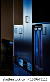 Interior Photography Detail Of Cabinetry And Bar Fridges In A Dark Toned Corporate Break Out Area In An Office