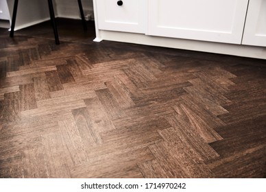 Interior photography detail of walnut stained parquetry flooring in a bedroom