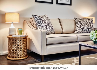 Interior Photography Of Hamptons Style Lounge Room With Cream Sofa, Framed Prints, Side Lamp And Table, Coffee Table And Rug