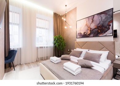 Interior photography, modern bedroom, with large stylish bed, modern design, in beige