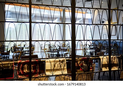 Interior Photography Of A Modern Bistro Restaurant At An RSL Club In Sydney Australia Shot Through A Metal Room Divider And Magazine Rack