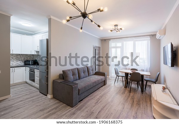 Interior photography, modern living room\
with kitchen studio, loft style, in bright\
colors