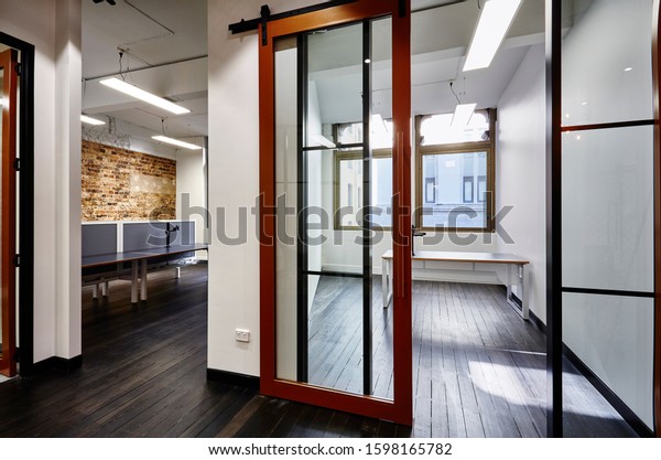 Interior photography of an open plan office in a\
warehouse conversion with empty office, open plan office cubicles,\
floor boards and exposed\
brick