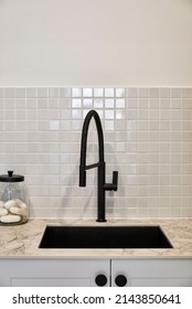 Interior Photography Of A Suburban Family Home, Detail Of A Laundry Room Sink, Tiled Splashback, Quartz Bench Top And Black Tap Ware.