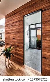 Interior Photography Of A Timber Feature Wall In A Contemporary Home Looking Into A Bathroom Through A Doorway