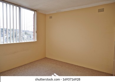 Interior photography of a vacant 1970's apartment lounge room with beige walls and carpet - Shutterstock ID 1693716928