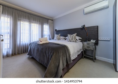 Interior Photos Of A Guest House Bedroom, Hotel, Motel With A Well Made Bed With White Linen