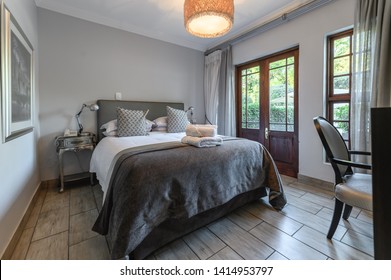 Interior Photos Of A Guest House Bedroom, Hotel, Motel With A Well Made Bed With White Linen