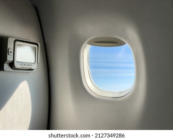 the interior of the plane is the plane window where we can see the view from the window and there is an airplane tv that we can watch 
