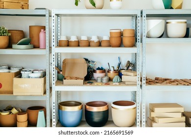 Interior Of Pottery Workshop: Shelves With Flower Pots, Vases And Work Tool In Store With No People