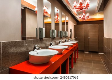 Interior of public washroom in restaurant with vintage red chandeliers