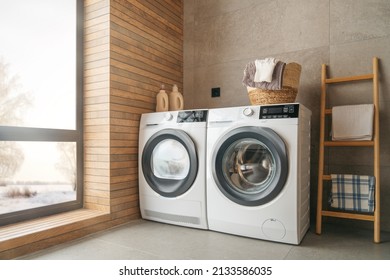 Interior of a real laundry room with a washing machine at home