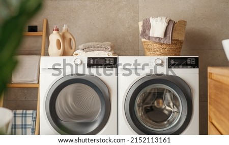 Interior of a real laundry room with a washing machine at home