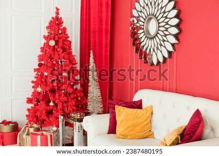 Interior with red Christmas tree, sofa, vintage mirror, lights and decorations