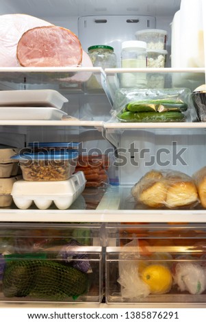 The interior of a refridgerator stocked with healthy food.