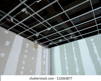 Interior Remodeling Work On An Existing Commercial Building - Ceiling Is Being Prepared For Electricity System And Wall Are Prepared For Painting