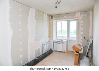 Interior Renovation Of A Residential Apartment Using Drywall Without Painting. Construction Work Indoors, Renovation Process Inside The House.